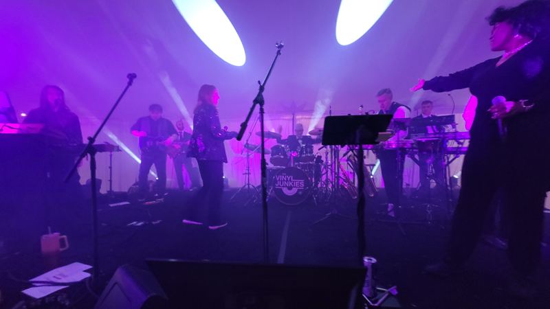Band on stage in purple light and haze